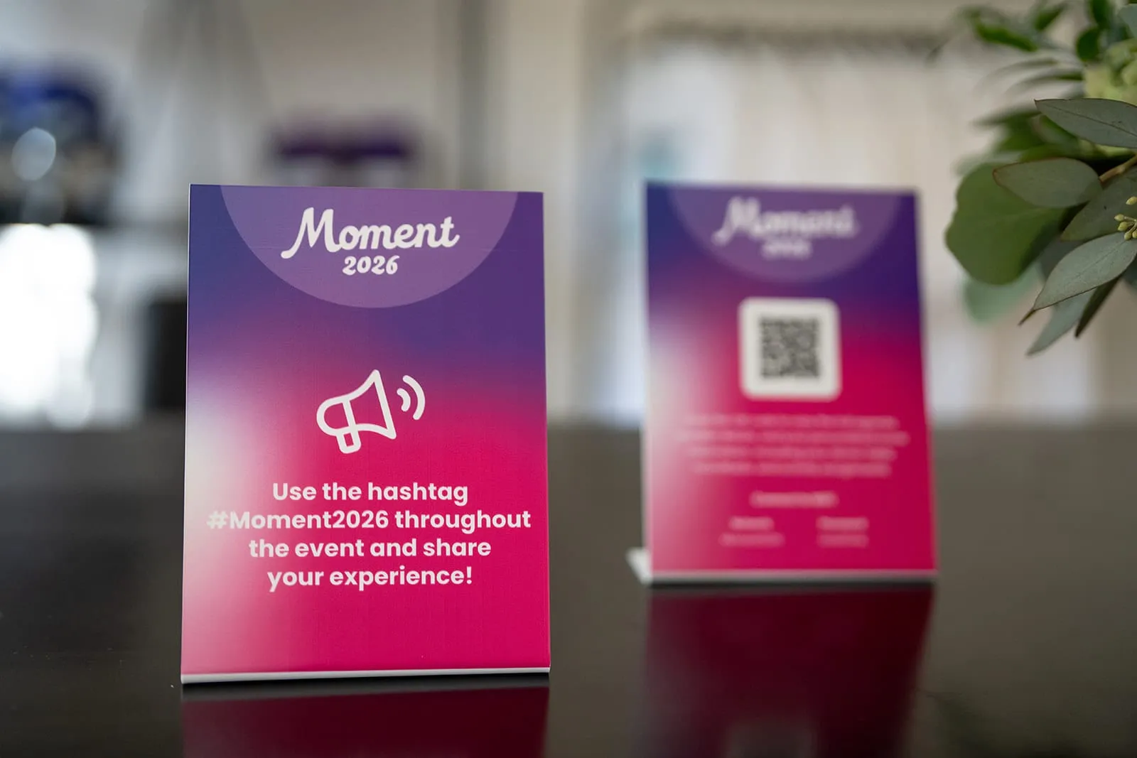 Table cards with a QR code and the event hashtag