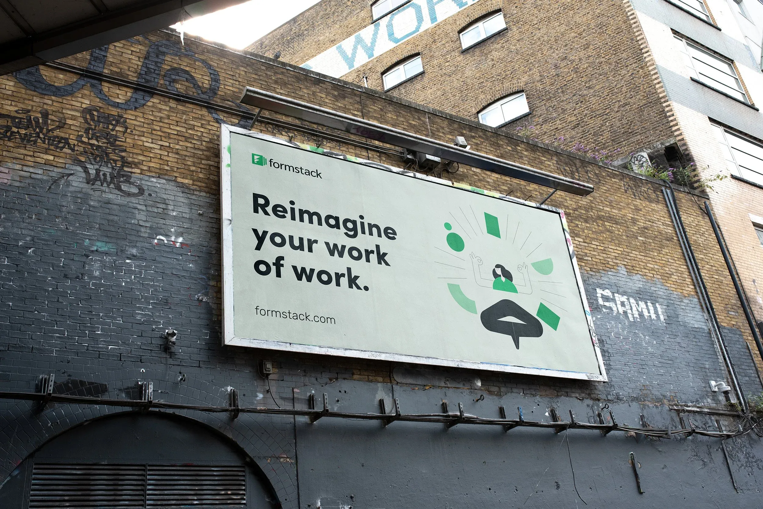 Formstack "Reimagine your work" billboard on a brick building